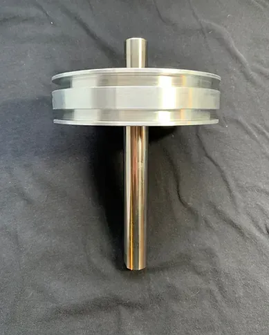 a metal object is sitting on top of a black cloth on a table .