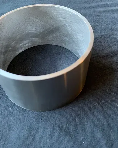 a metal ring is sitting on a black cloth on a table .