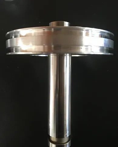 a close up of a stainless steel object on a black surface .