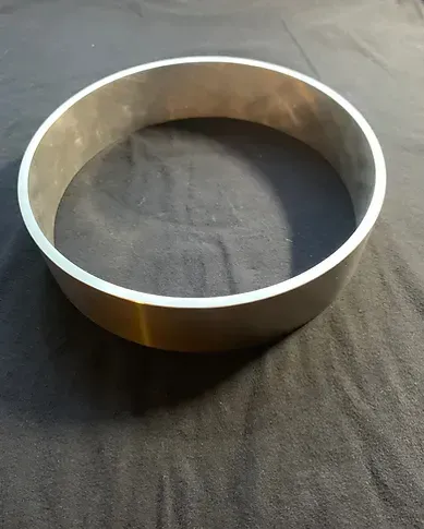 a metal ring is sitting on top of a black cloth .