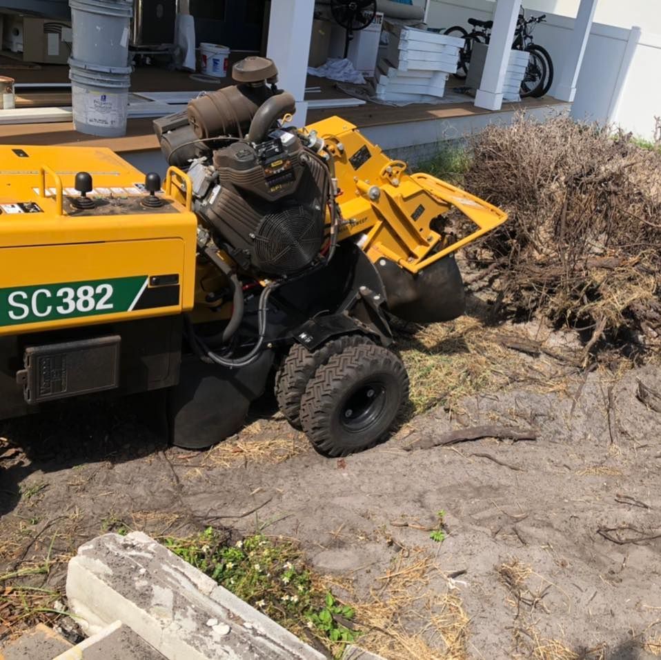A yellow sc382 stump grinder is sitting in the dirt