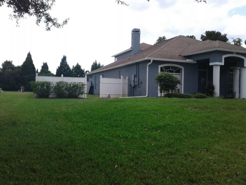 A house with a large lawn in front of it