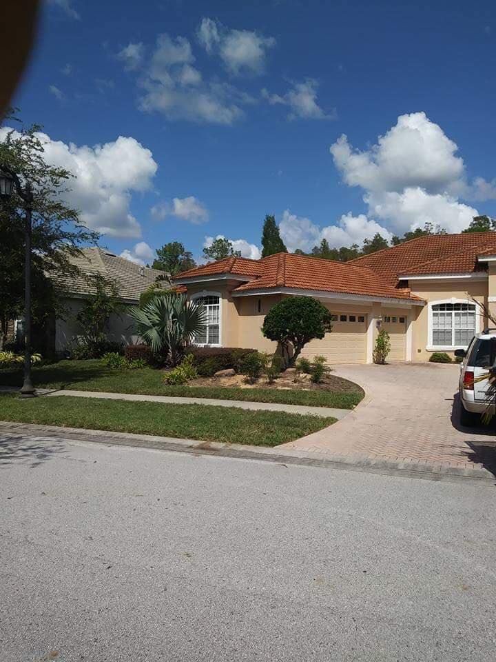 A house with a car parked in front of it