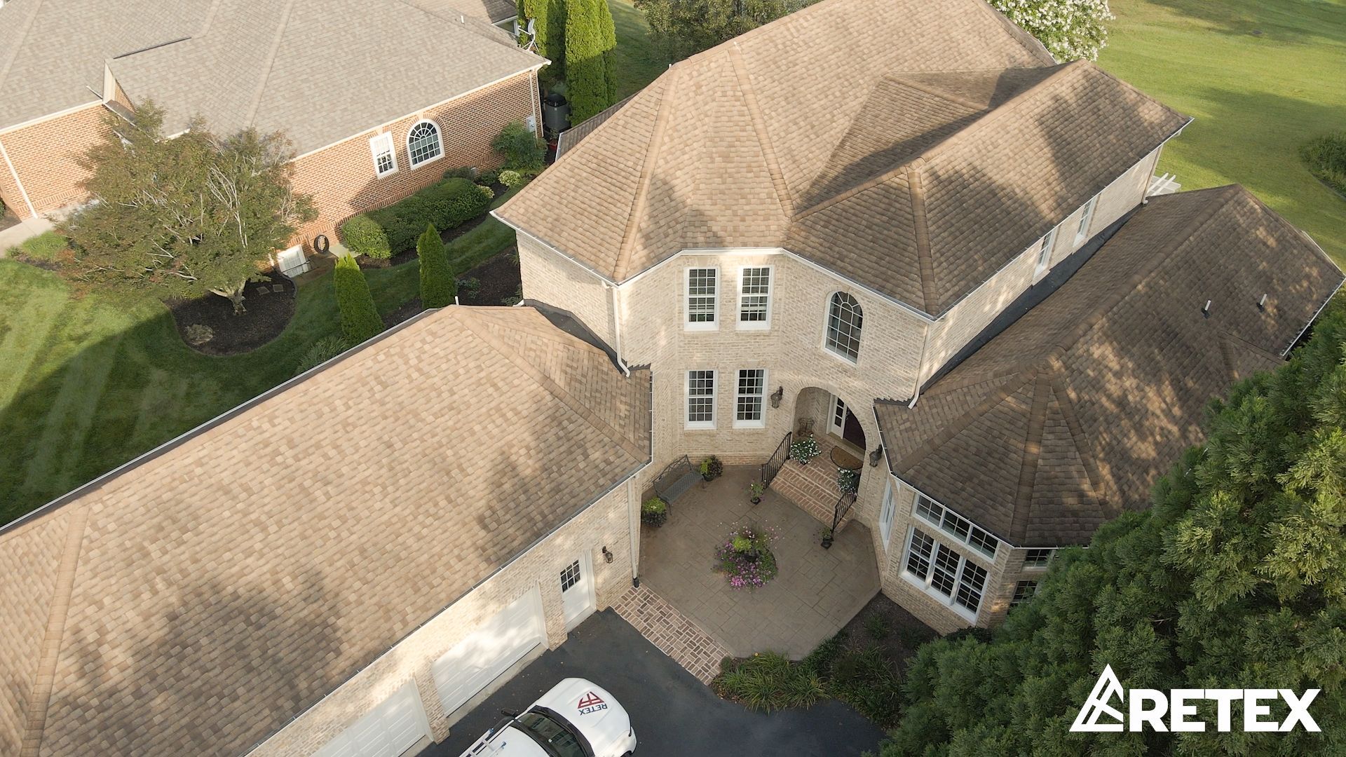 Drone image of RETEX roof replacement in Bon Air VA 23235. Tamko Titan Olde English asphalt shingles and TPO flat roof.
