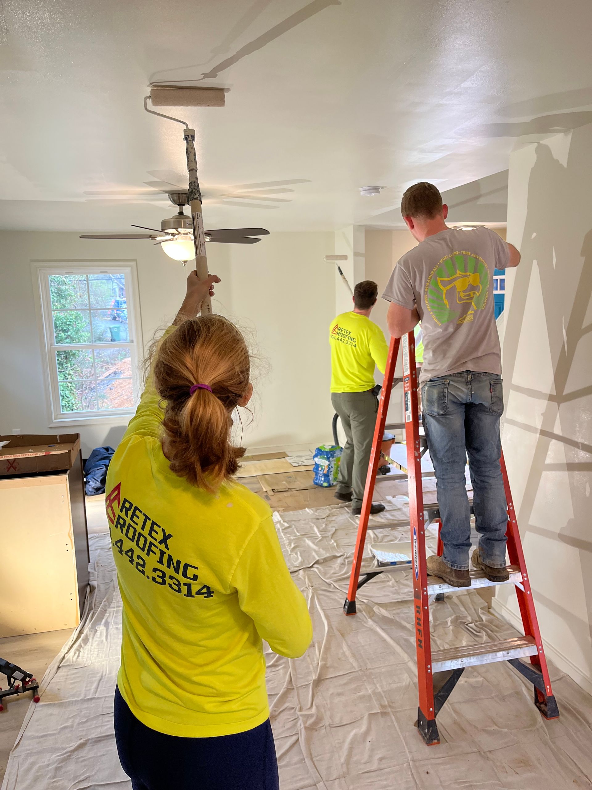 Image of RETEX's Katelyn and Josh Lewis volunteering by painting at Richmond Habitat for Humanity in January 2022.