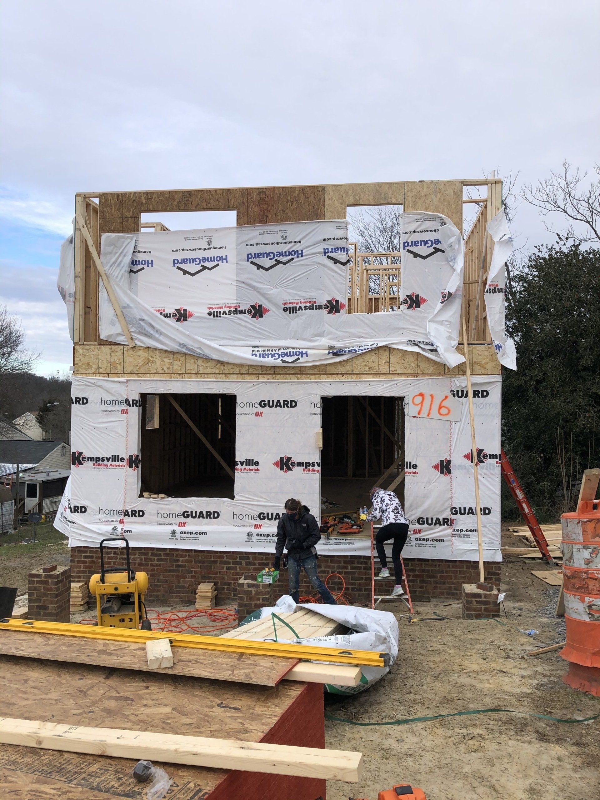 Image of RETEX's Katelyn Lewis entering a Richmond Habitat for Humanity build site during a volunteer day.