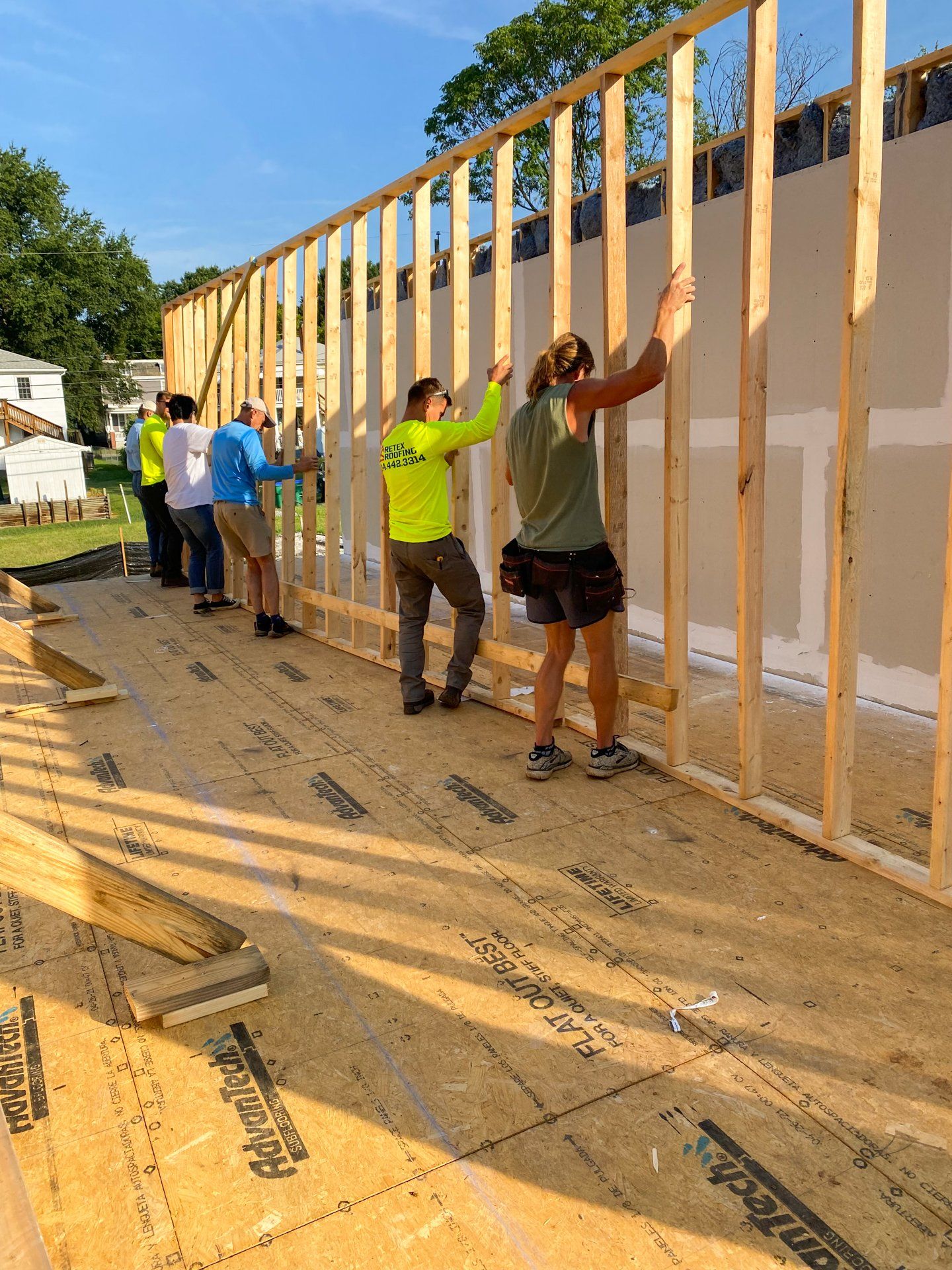 Image of RETEX's Josh Lewis, Caleb Kammerling and other volunteers installing framing for Richmond Habitat for Humanity.