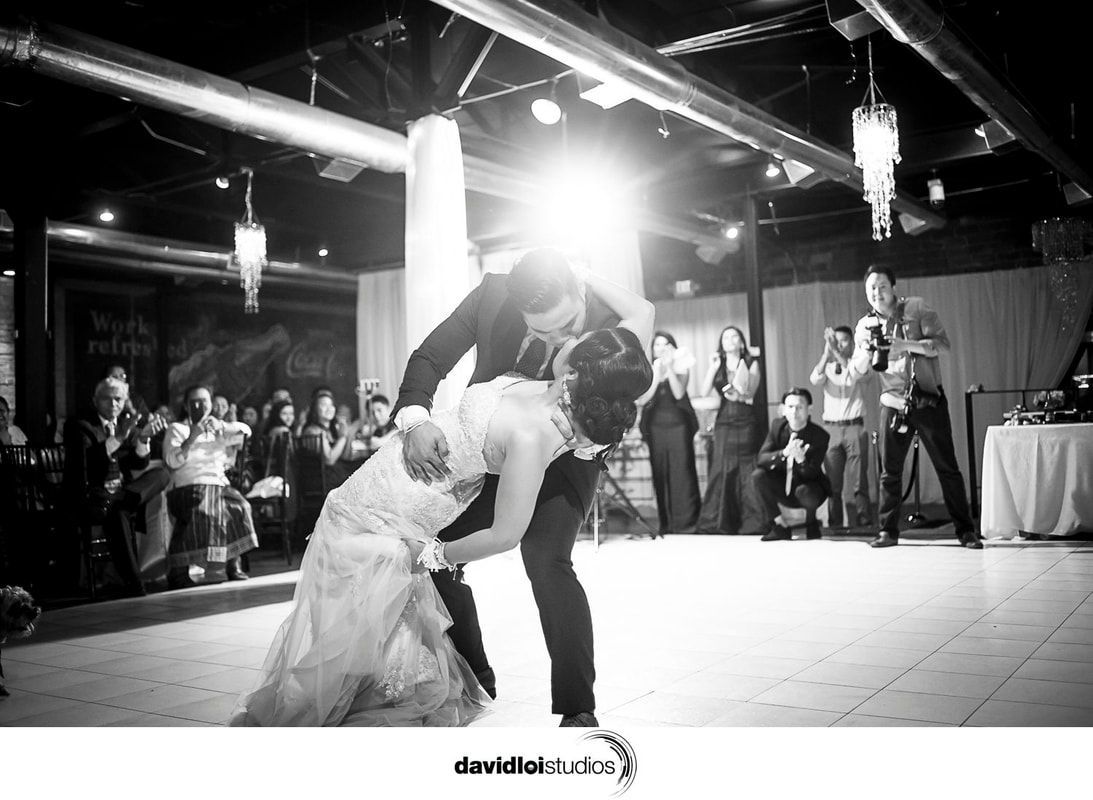 A bride and groom are dancing their first dance at their wedding reception.
