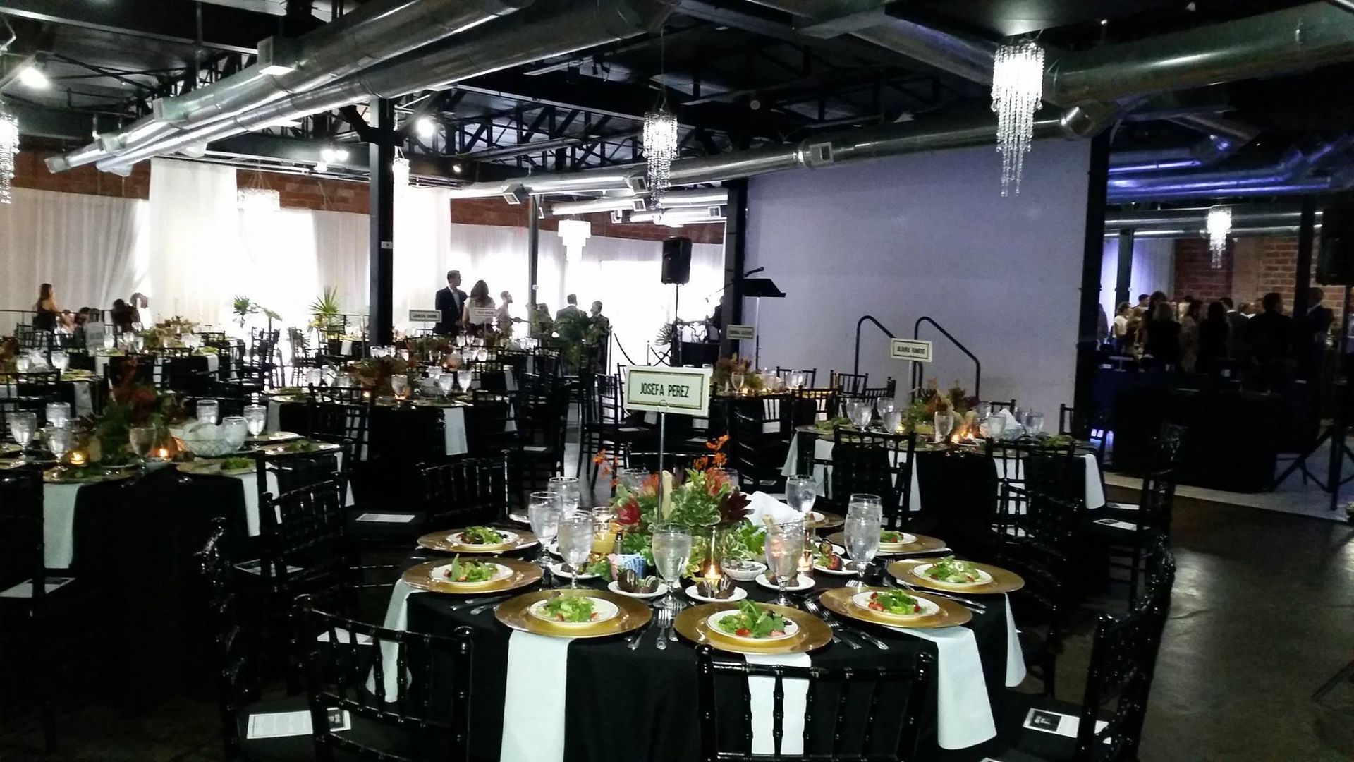 A large room filled with tables and chairs set up for a party.