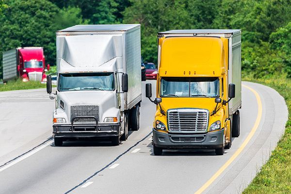 Motorboat speeding across water, city skyline and bridge in the background.