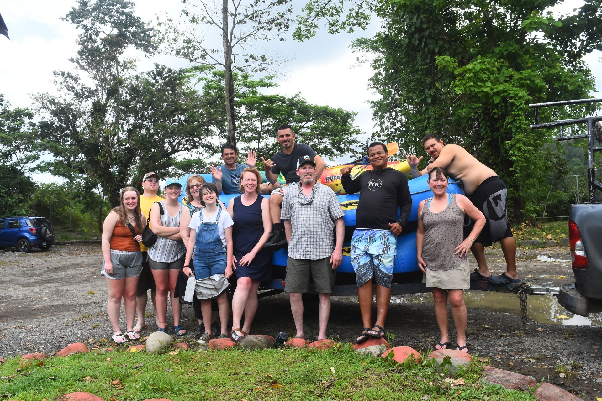 A group of people are posing for a picture in front of a truck.