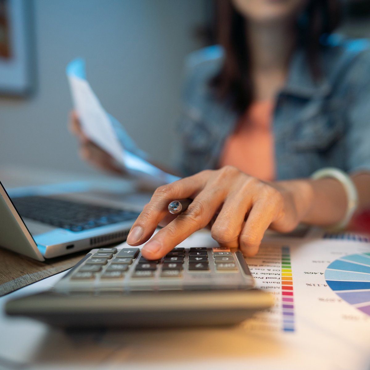 Woman Using Calculator — Dallas, NC — Xpress Tax & Accounting, Inc