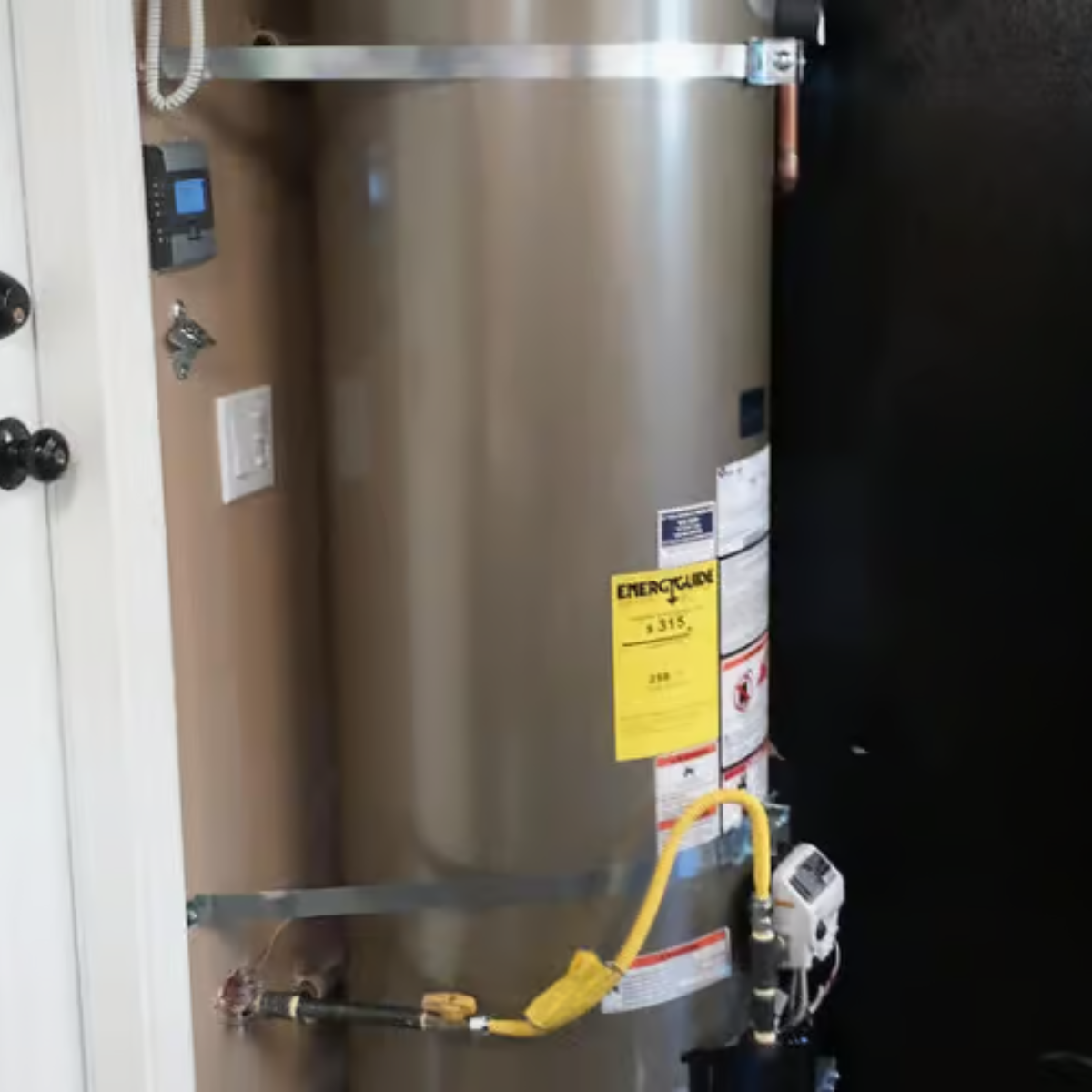 A statue of a mosaic head is sitting on a wooden stump.