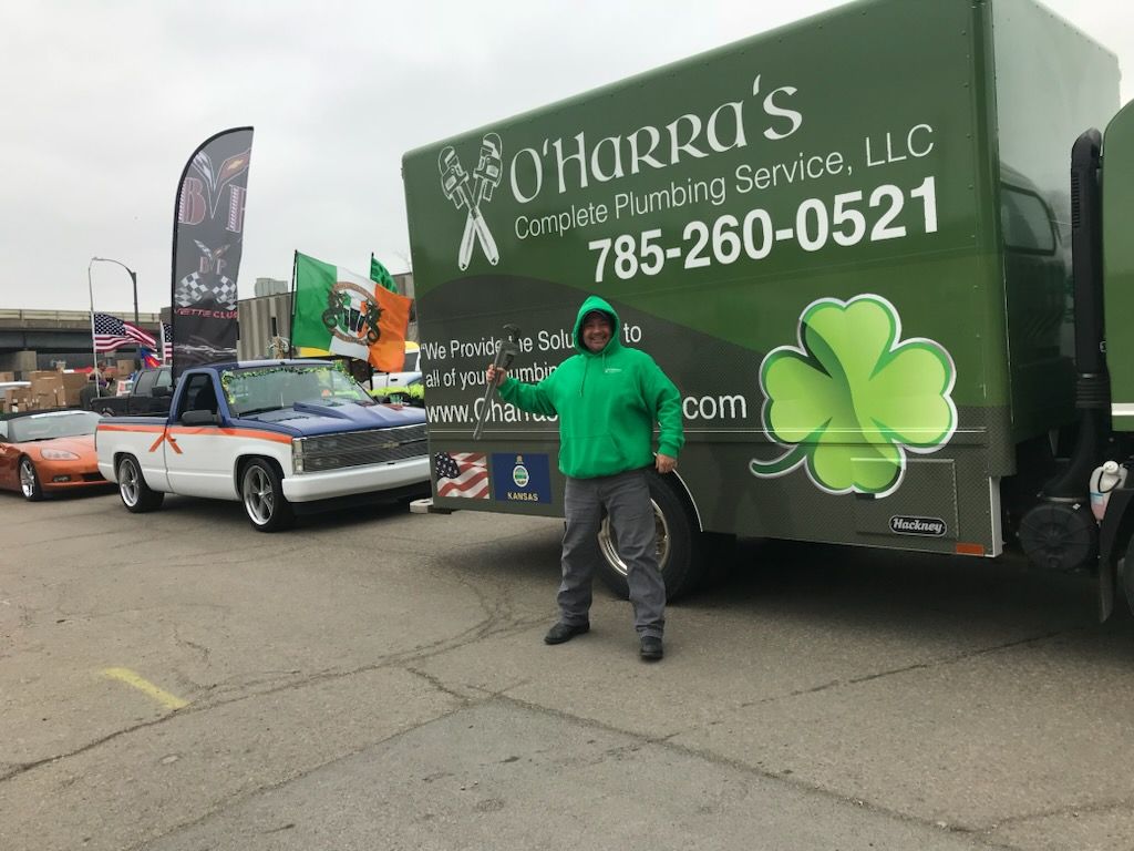 A close up of an air conditioner being repaired with gauges attached to it.