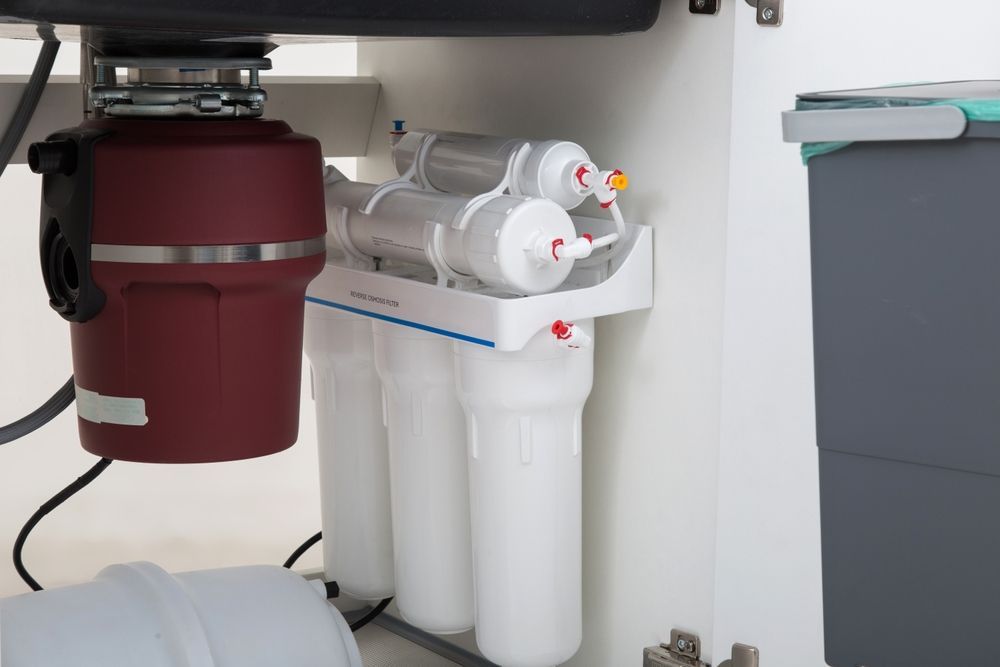 A chair with a yellow pillow and a necklace on it