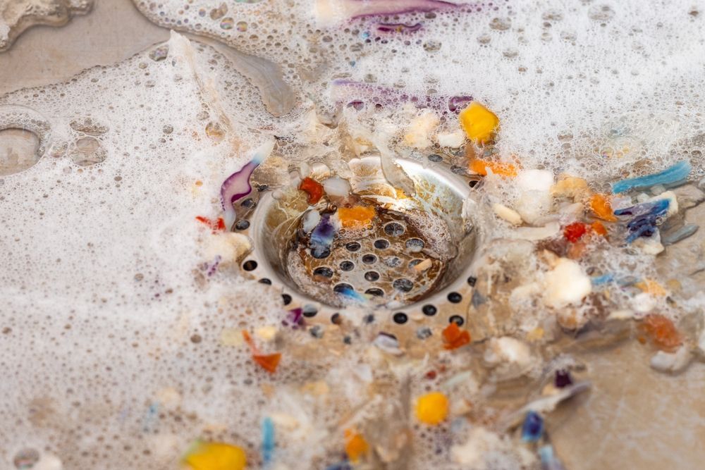A bunch of incense sticks are sitting on top of each other on a table.