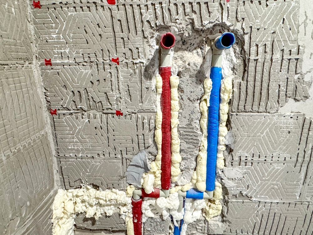 A chair with a yellow pillow and a necklace on it