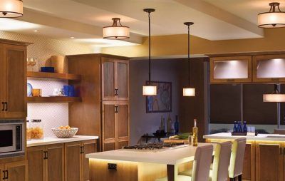 A kitchen with wooden cabinets and a large island