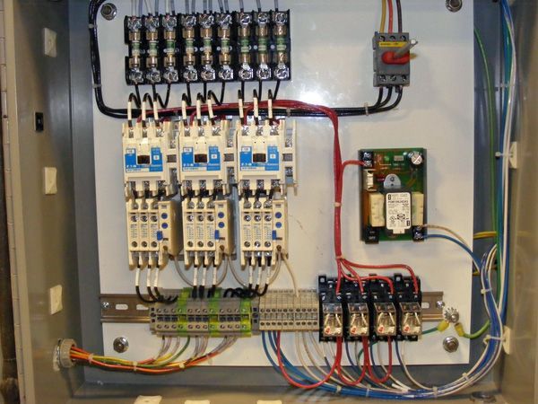 The inside of an electrical box with a lot of wires