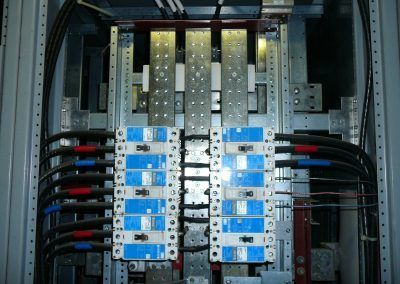 A bunch of wires are connected to a electrical panel