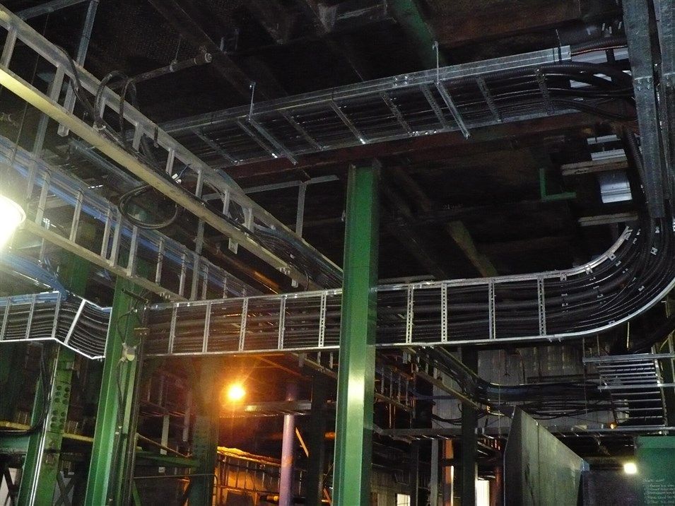 A warehouse with a lot of wires hanging from the ceiling