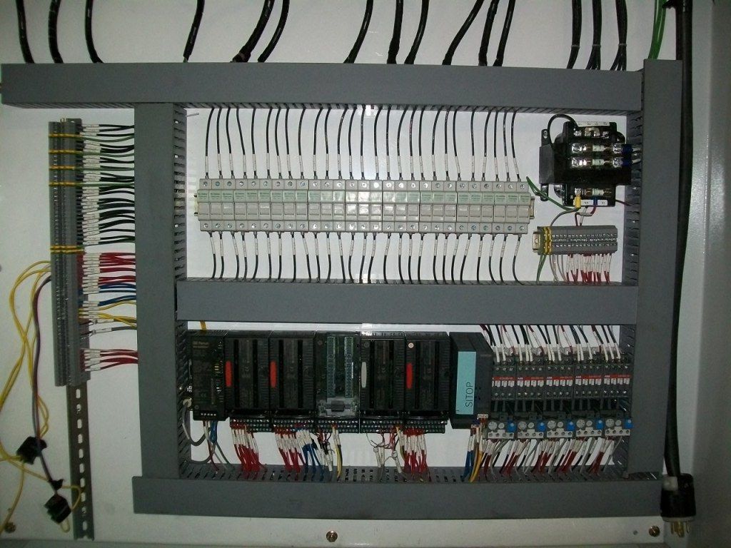 A control panel with a lot of wires on it