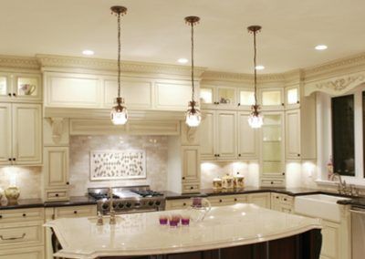 A kitchen with white cabinets and a large island