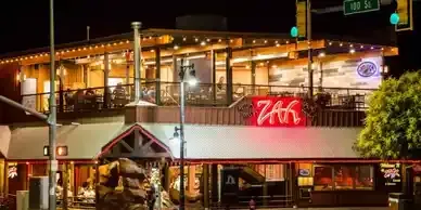 A large building with a lot of windows is lit up at night.