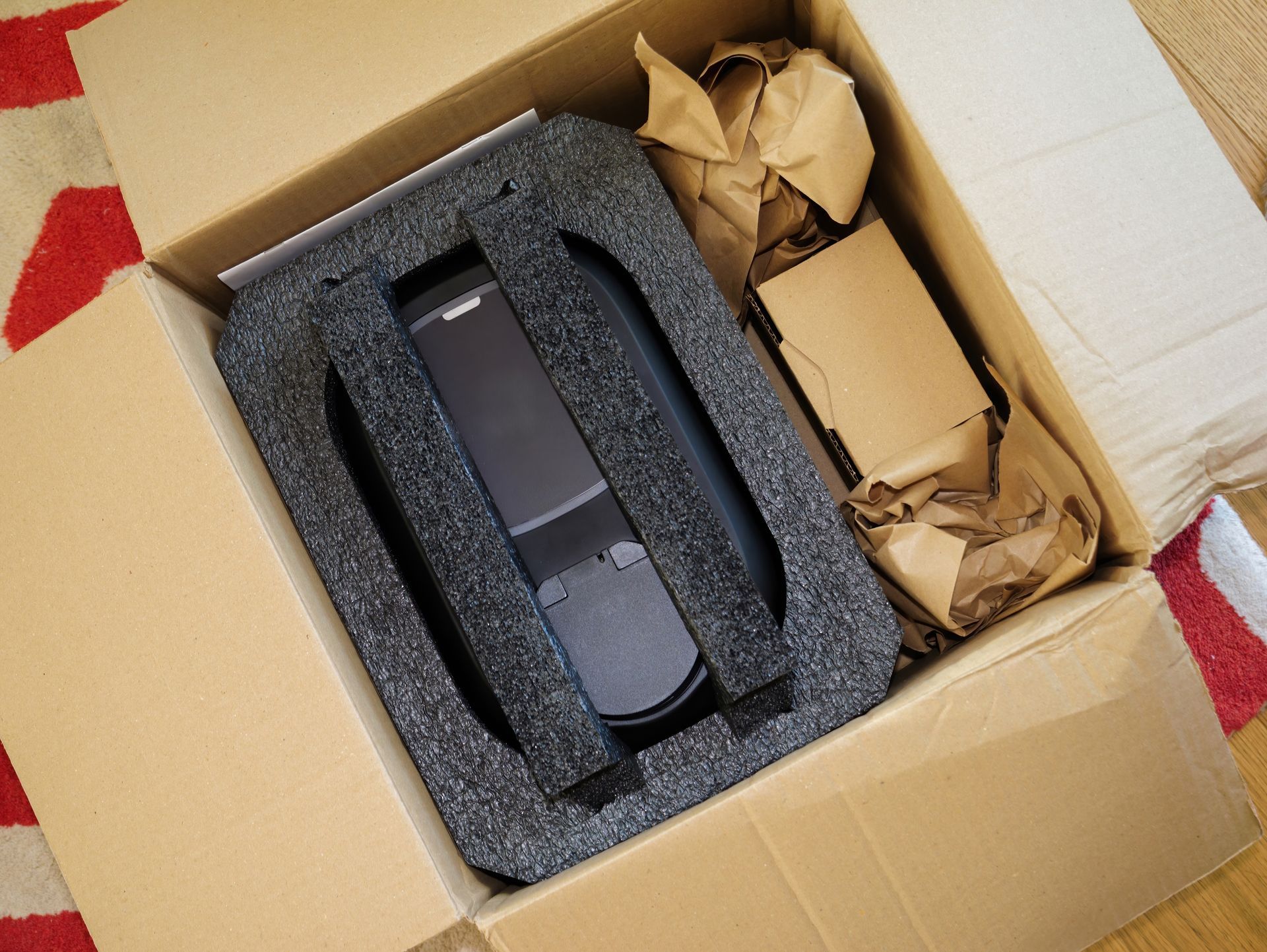 A cardboard box with a black object inside of it