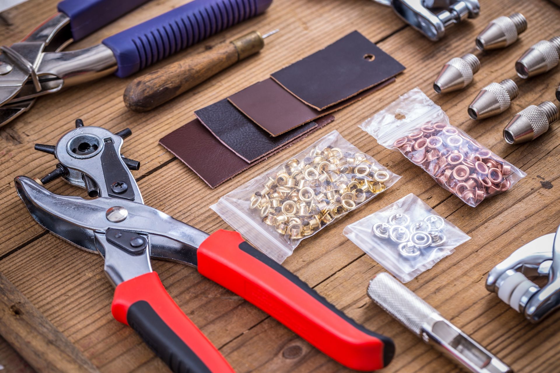 A bunch of tools are sitting on a wooden table.