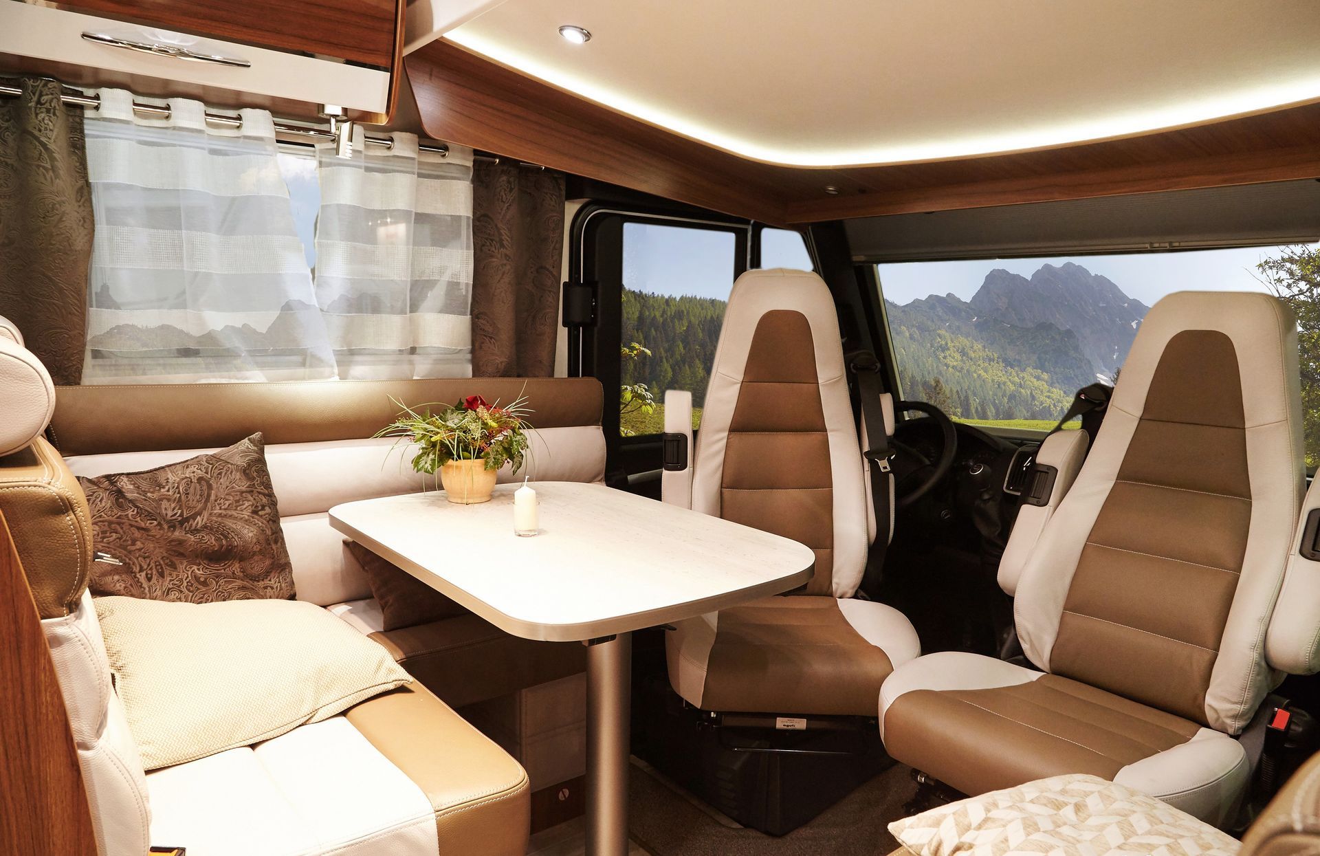 The inside of a camper with a table and chairs