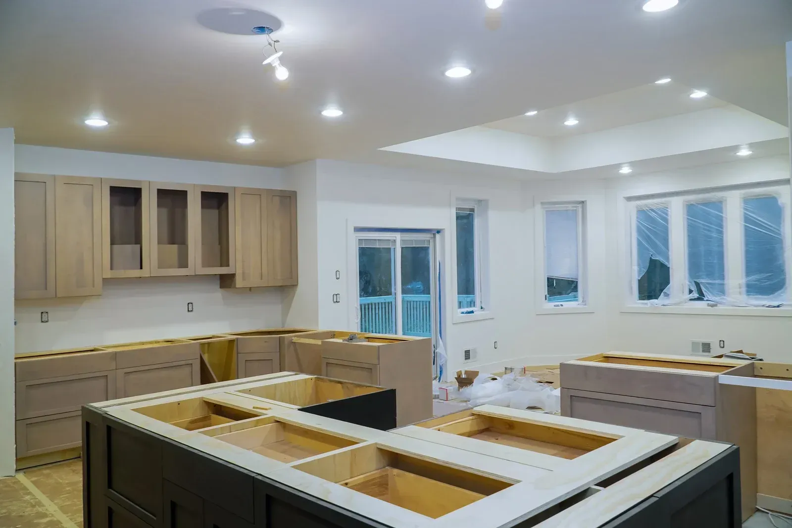 A kitchen under construction with wooden cabinets and counter tops.