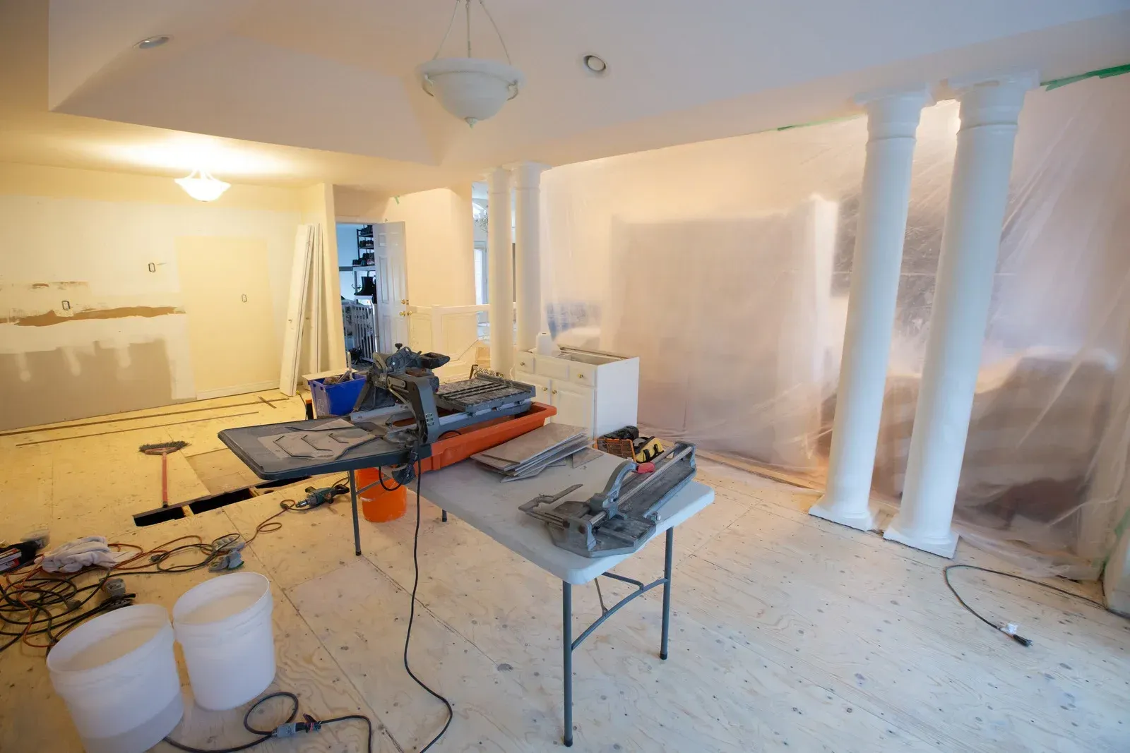 A room with a table and a vacuum cleaner in it