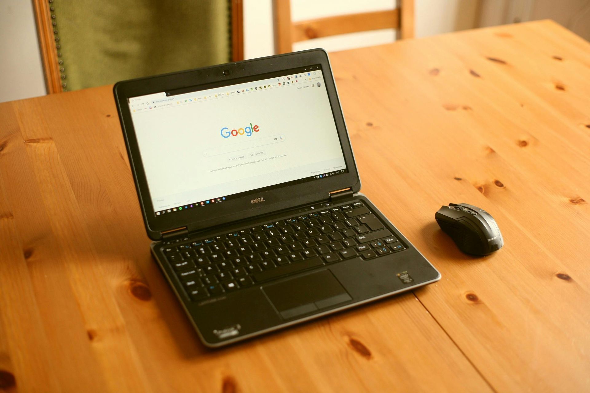 A woman is sitting on the floor using a laptop computer.