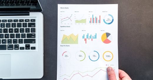 Photo of a computer and printout of analytics related to an SEO Audit.
