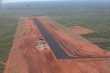 An aerial view of a runway in the middle of a field.