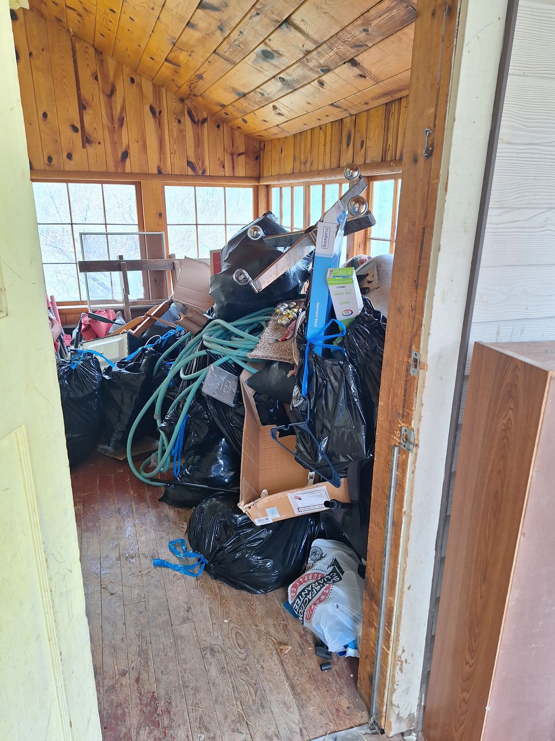 Before junk removal showing a cluttered room