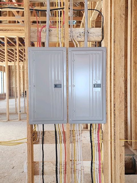 An air conditioning unit mounted below a window on a green building with white trim.