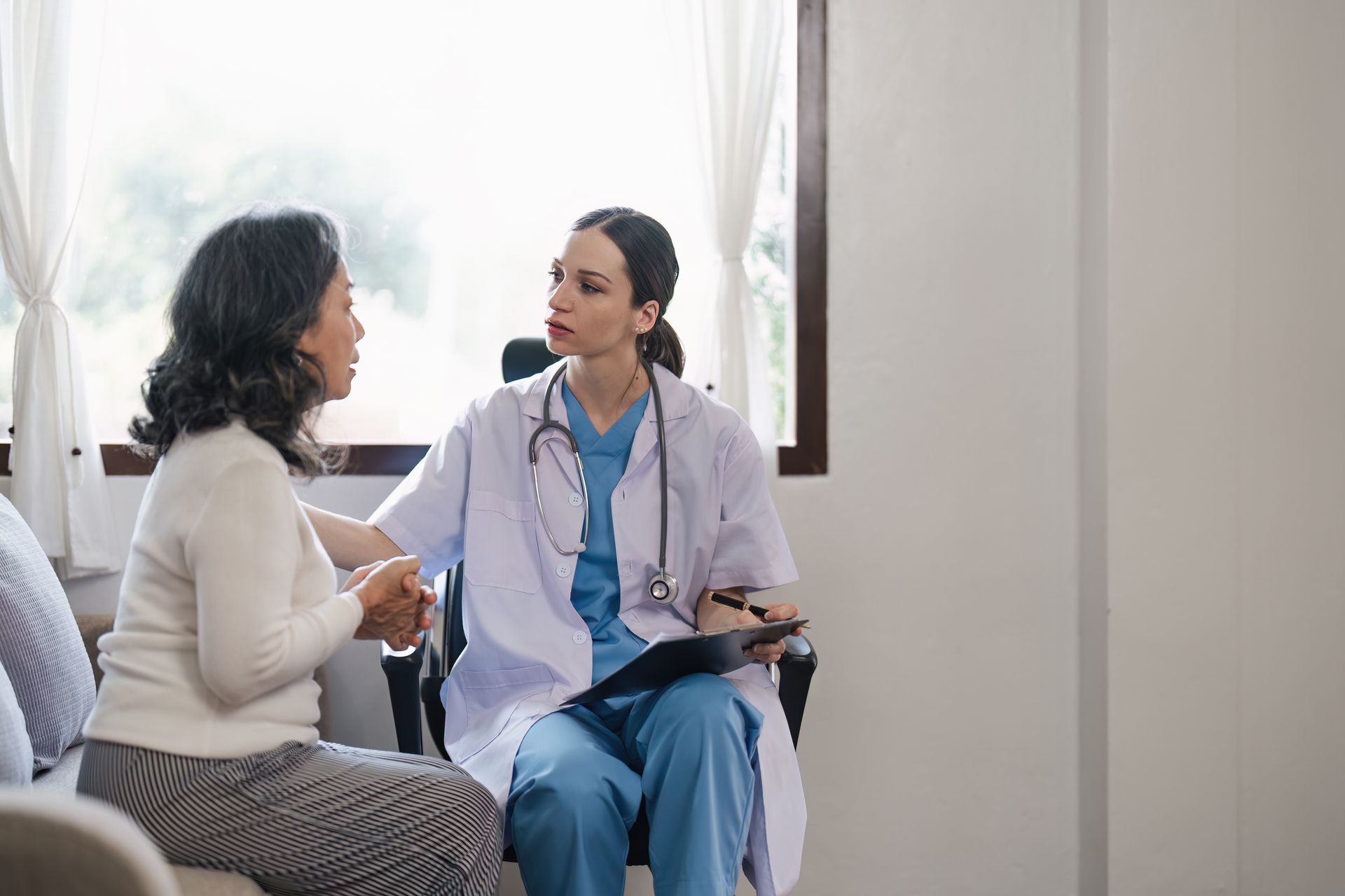 A doctor is talking to a patient in a hospital room.