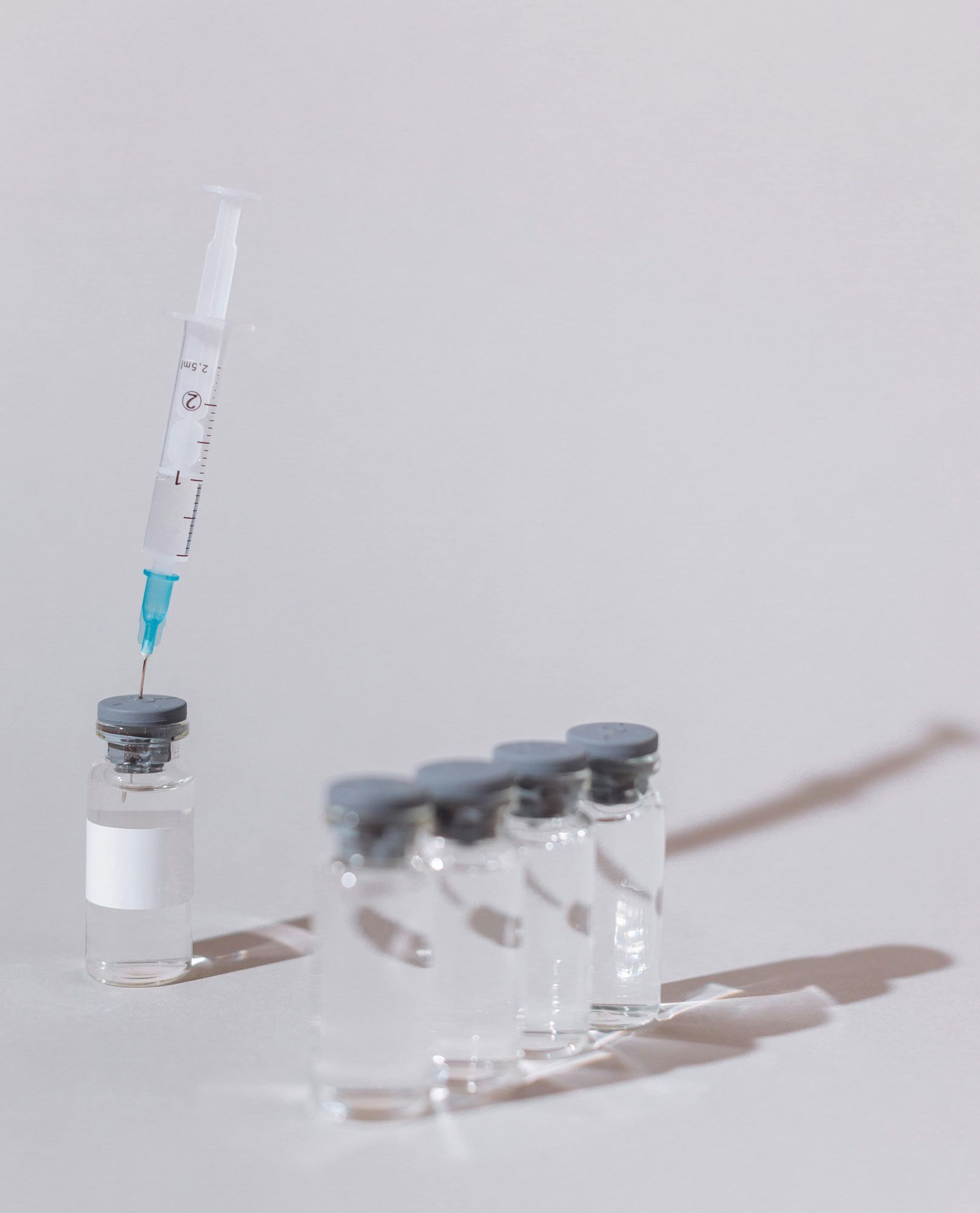 A syringe is being poured into a bottle of liquid medicine.