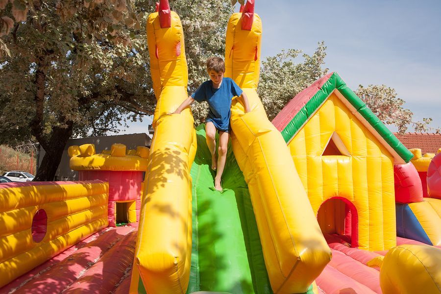 a man is sitting on a large inflatable slide