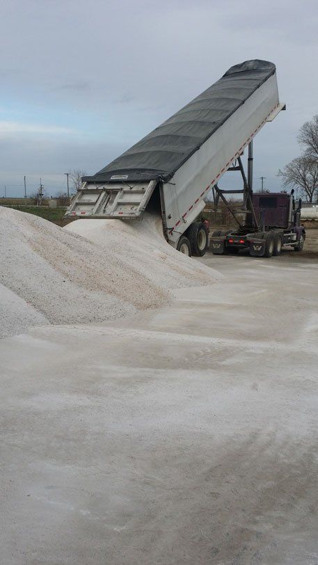 Close Up of Commercial Vehicle Dropping Salt on a Road — Bloomington, IL — McLean County Asphalt Co.