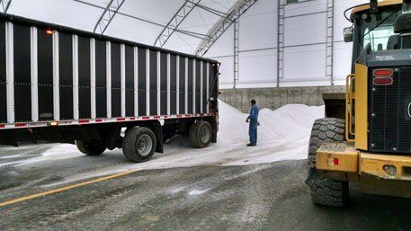 Man Standing in Front of 10 Wheeler Truck — Bloomington, IL — McLean County Asphalt Co.