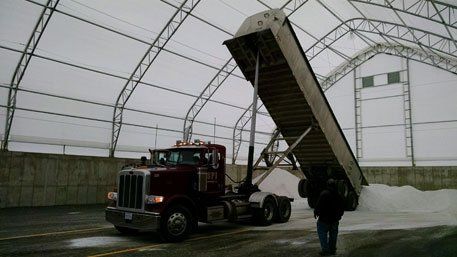 Side View of Commercial Vehicle Dropping Salt on a Stadium — Bloomington, IL — McLean County Asphalt Co.
