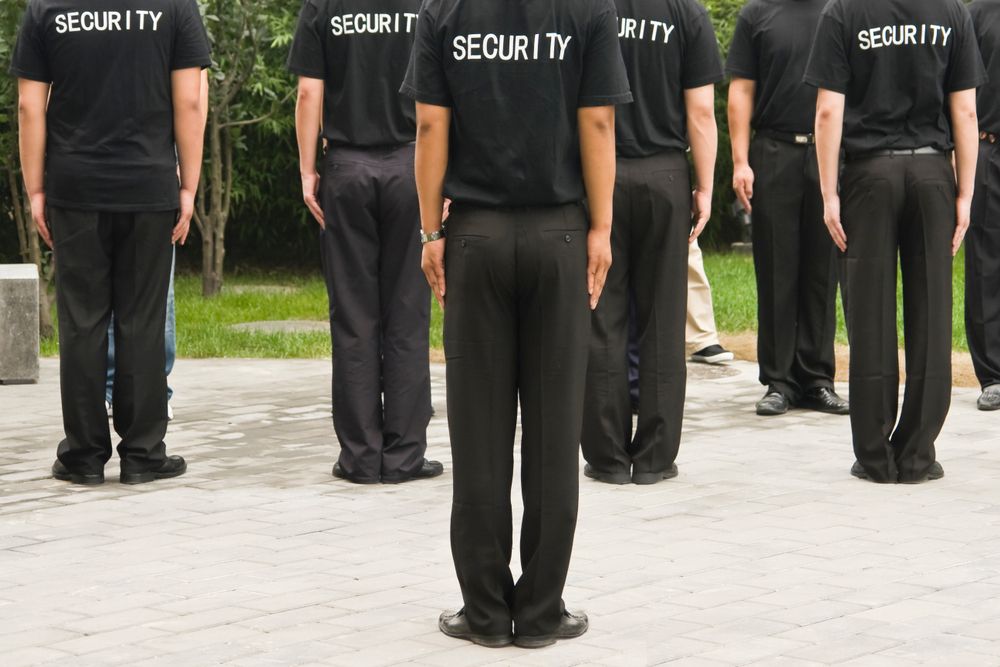 A Group of Security Personnel in Black Uniforms Standing at Attention — Clinton Security Services In Dubbo, NSW