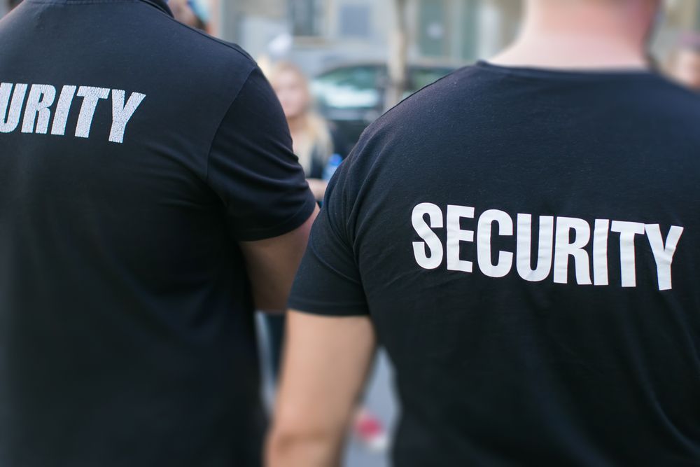 A Two Security Guards in Black Shirts — Clinton Security Services In Tamworth, NSW