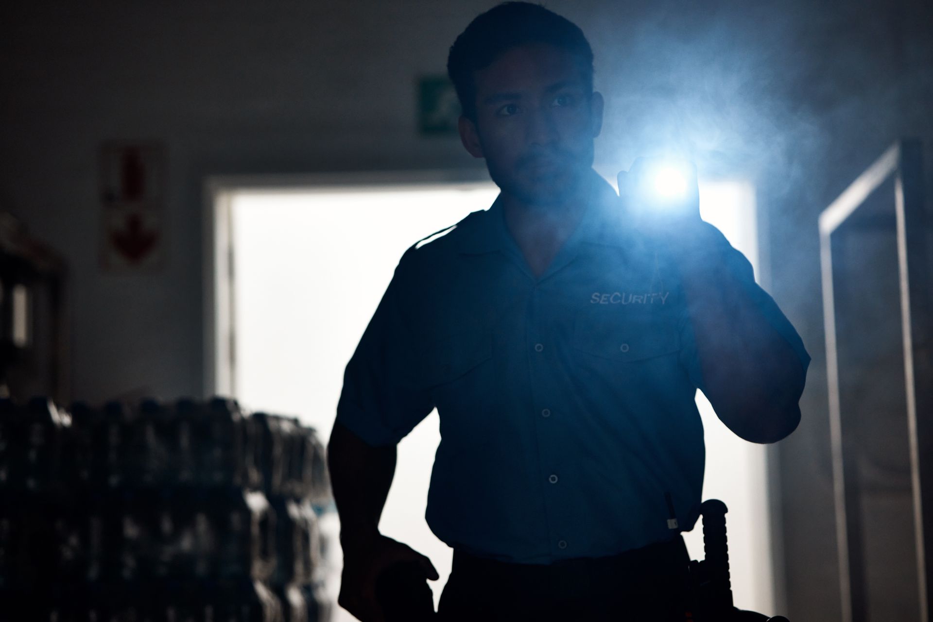 A Man in Dark Room, Silhouetted, Holding Flashlight, Inspecting — Clinton Security Services In Coffs Harbour, NSW