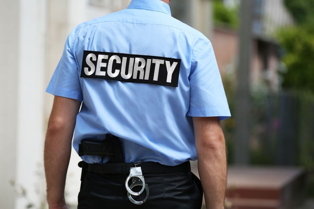 A Security Guard in Blue Uniform, Black Pants — Clinton Security Services In Brisbane, QLD