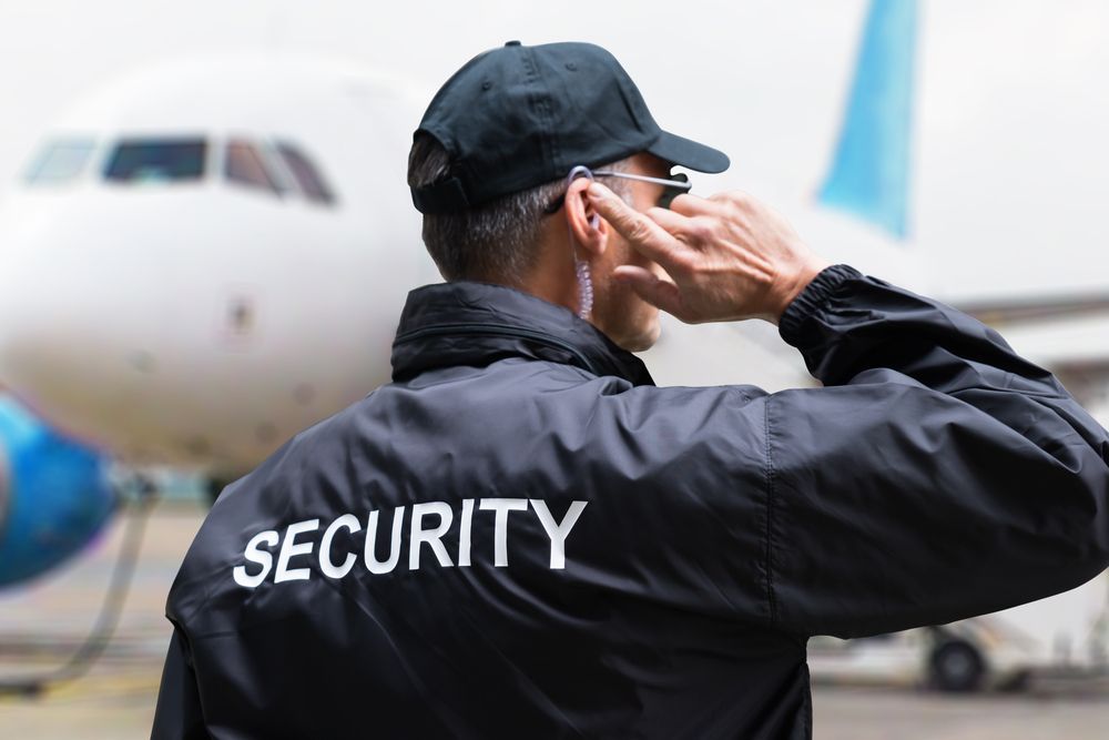 Security Guard in Black Jacket With Ear Piece — Clinton Security Services In Armidale, NSW