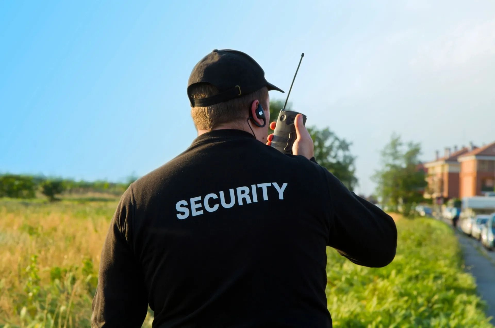 Security Guard in Black Uniform, Talking on Radio — Clinton Security Services In Armidale, NSW